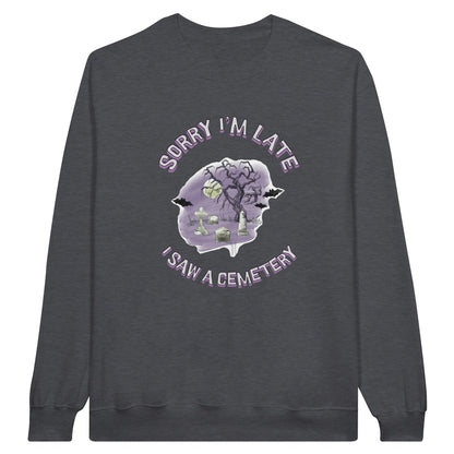 Gildan 18000 Crewneck Sweatshirt with the words Sorry I'm Late I saw a cemetery around a graphic of a cemetery.  Colors of the graphic are purple and grey. Sweatshirt is Dark Heather Grey