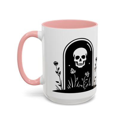 15 oz white ceramic mug with black text and graphics and  a pink handle and pink interior. One side says Introverted but willing to discuss cemeteries the other side has a tombstone with a skull on it