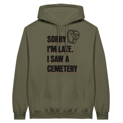 Gildan 18500 Hoodie Sweatshirt with the words Sorry I'm Late. I Saw A Cemetery in black and a small skull and coffin graphic to the top right of the text. Hoodie is  military green