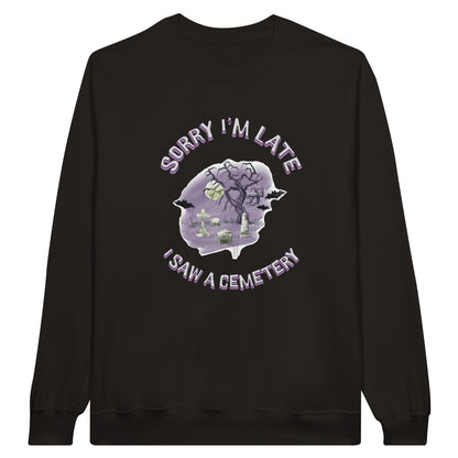 Gildan 18000 Crewneck Sweatshirt with the words Sorry I'm Late I saw a cemetery around a graphic of a cemetery.  Colors of the graphic are purple and grey. Sweatshirt is black