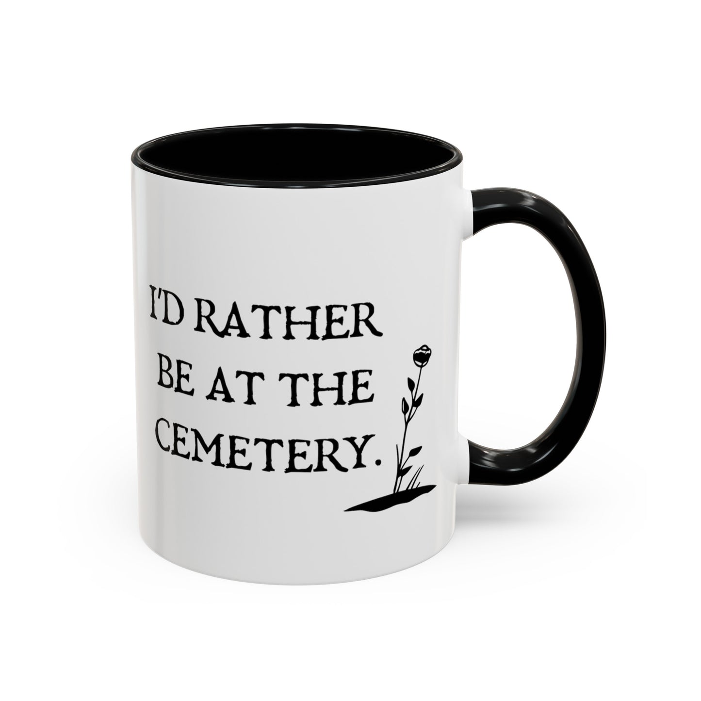 15 oz white ceramic mug with a black handle and black interior. One side says Id rather be at the cemetery the otherside has a tombstone with a skull on it