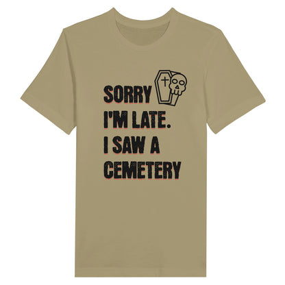 Bella Canvas 3001 T-Shirt with  the words Sorry I'm Late. I Saw A Cemetery in black and a small skull and coffin graphic to the top right of the text. Shirt is athletic tan