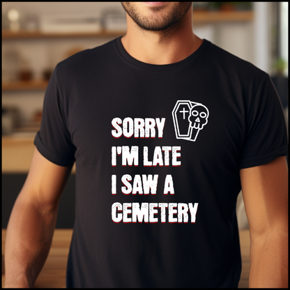 Bella Canvas 3001 T-Shirt with  the words Sorry I'm Late. I Saw A Cemetery in white and a small skull and coffin graphic to the top right of the text. Shirt is black.