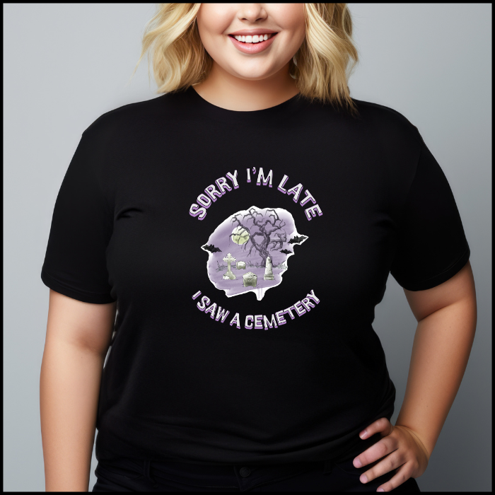 Bella Canvas 3001 T-Shirt  with the words Sorry I'm Late I saw a cemetery around a graphic of a cemetery.  Colors of the graphic are purple and grey. T-shirt is black.